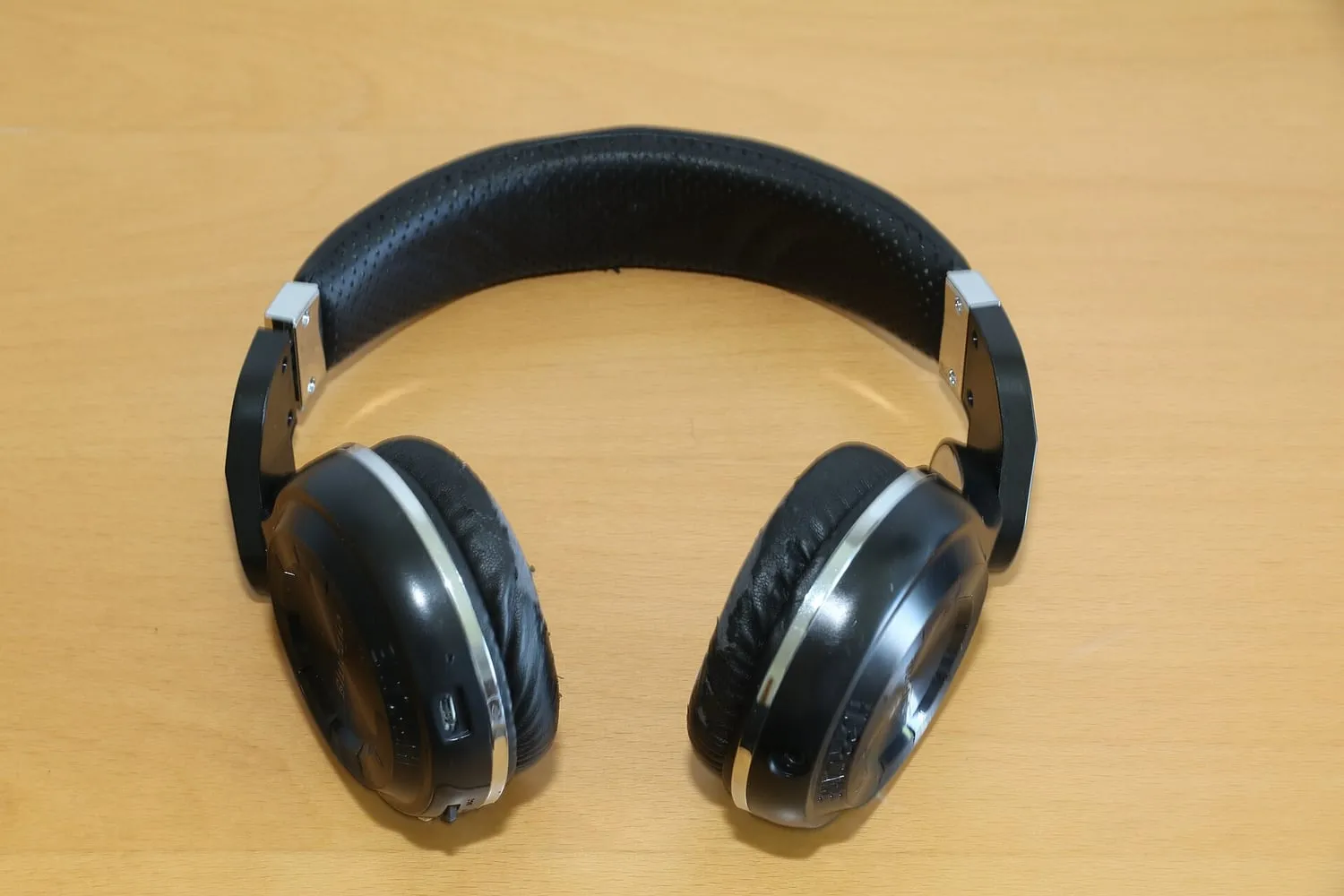 A pair of over-ear headphones photographed against a plain background